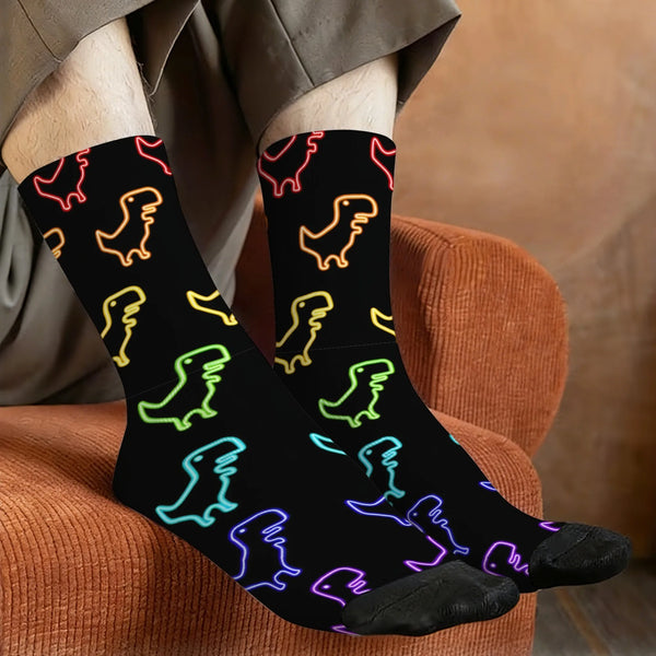 Gay dinosaur socks with colorful neon dinosaur outlines, modeled while resting on a rust-colored chair