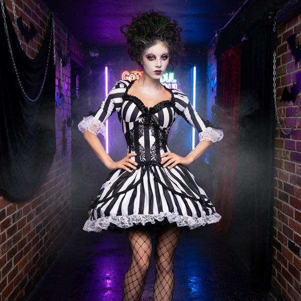 B&W Ghost Bride Costume on a femme with bold makeup, teased green hair, and neon-lit hallway Beetlejuice goth realness.
