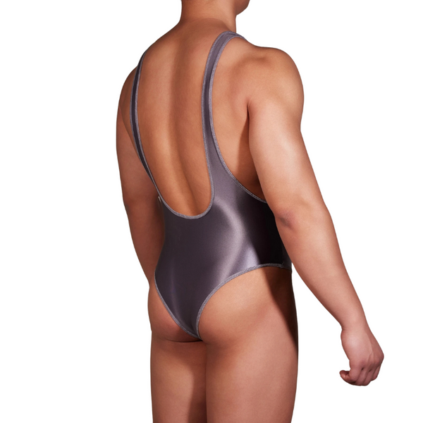 Rear three-quarter view of a model wearing a dark metallic U-neck bodysuit with a low scoop back.