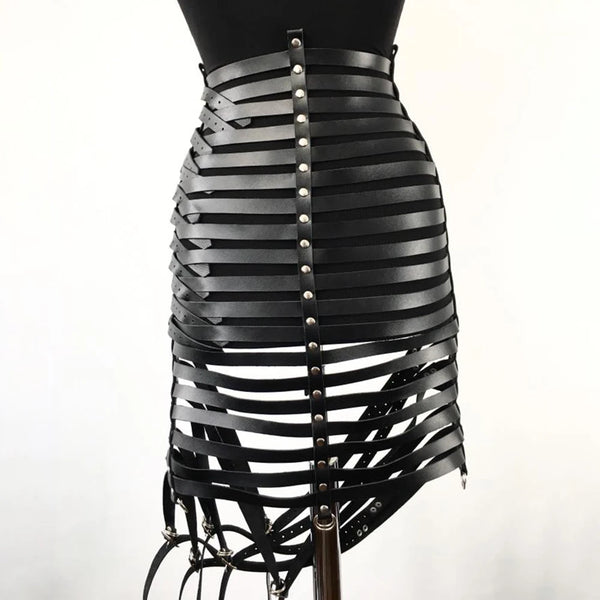 Close-up rear view of a black leather bondage harness with layered straps and metal studs