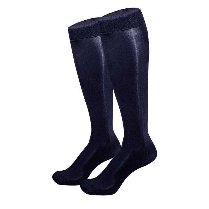 Pair of dark navy, glossy over-the-knee stockings displayed upright on a white background