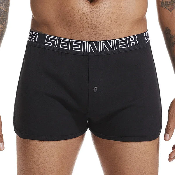 Front view of a model wearing black boxer briefs with a white Seeinner waistband