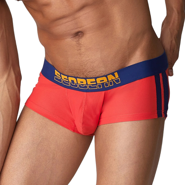Close-up model view of red boxer briefs with a navy waistband and side stripes