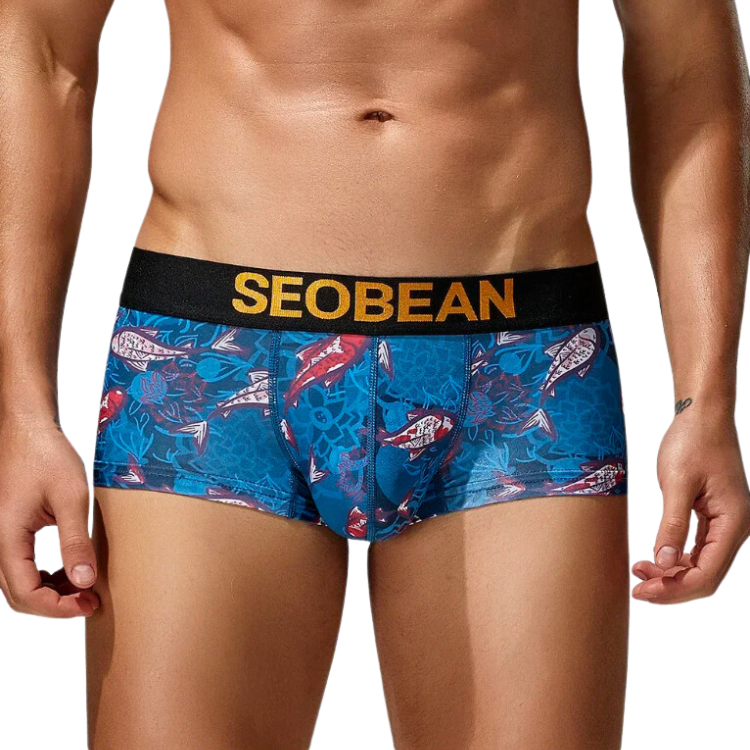 Front view of a model wearing blue fish-print boxer briefs with a black SEOBEAN waistband