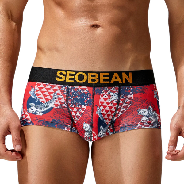 Front view of a model wearing red fish-pattern boxer briefs with a black SEOBEAN waistband
