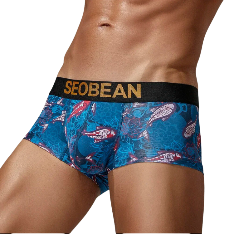 Front view of a model wearing blue fish-print boxer briefs with a black SEOBEAN waistband