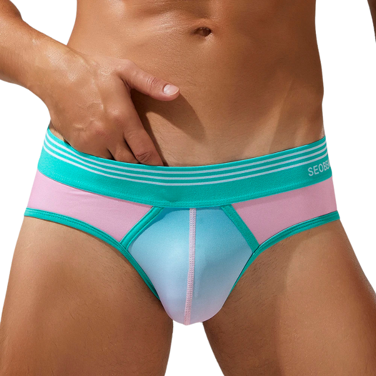 Front view of a model wearing turquoise and pink color-block boxer briefs