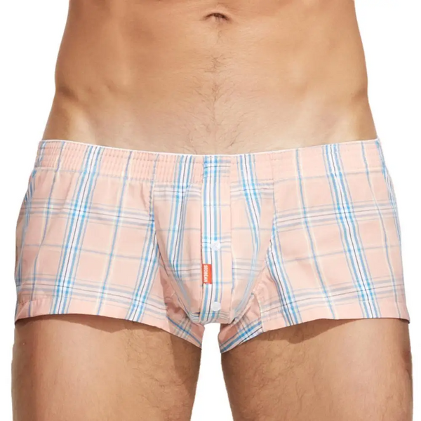 Front view of a model wearing peach plaid cotton boxer briefs with a fly