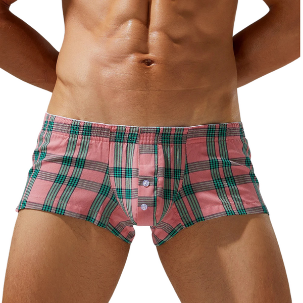 Front view of a model wearing pink and green plaid cotton boxer shorts