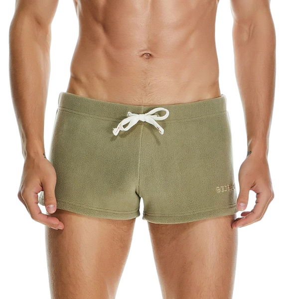 Front view of a model wearing olive-green fleece shorts with a white drawstring