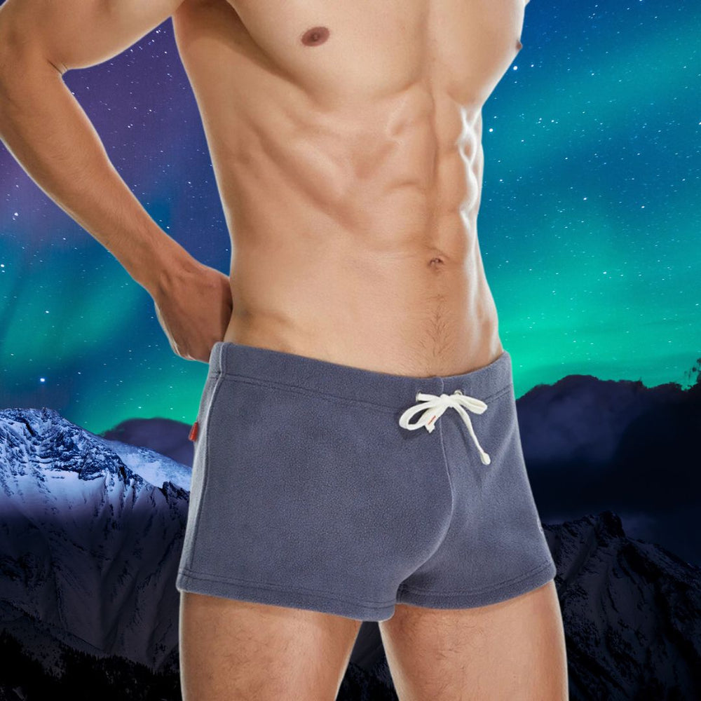 Front view of a shirtless model wearing slate-gray fleece shorts with a white drawstring