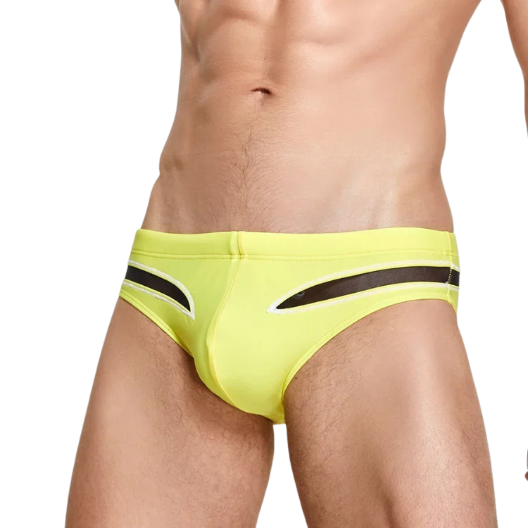 Front view of a person wearing lime green mesh swim briefs with black cutout panels