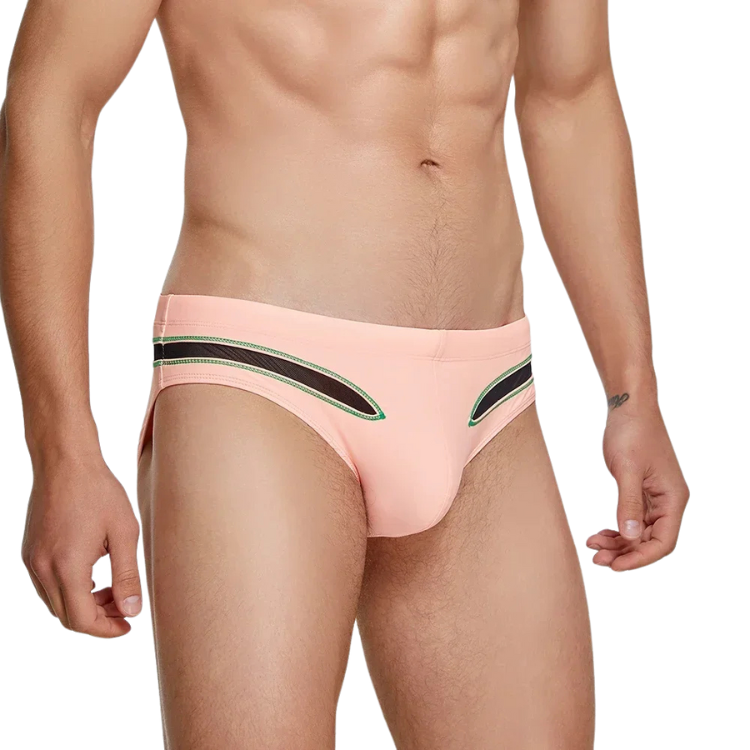 Front view of a model wearing pink mesh-panel swim briefs with green and black trim