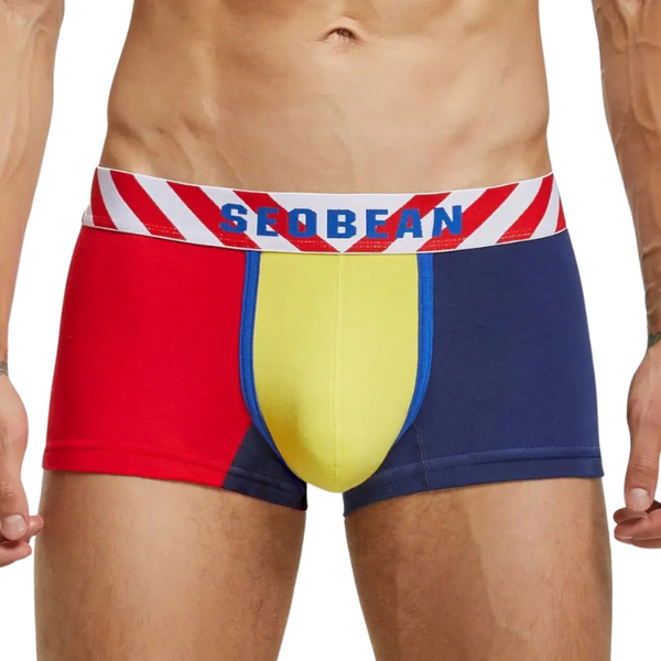 Front view of a model wearing red, yellow, and navy boxer briefs with a striped SEOBEAN waistband