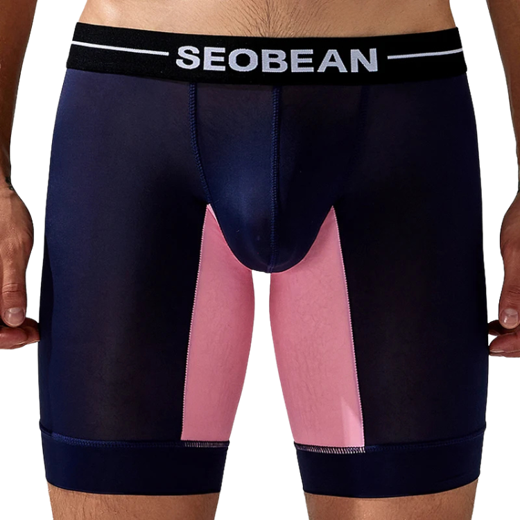 Front view of a model wearing navy long boxer briefs with a pink inner panel
