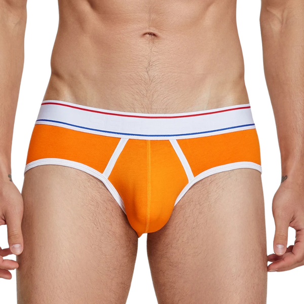 Front view of a model wearing orange men's briefs with white trim and striped waistband