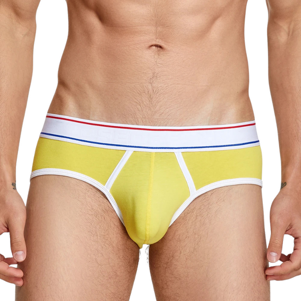 Front view of a model wearing yellow retro briefs with white trim and striped waistband