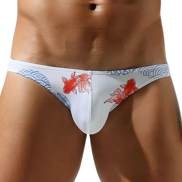 Front view of a model wearing white ultra-low-rise briefs with red koi fish and blue wave designs