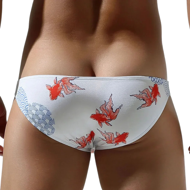 Front view of a model wearing white low-rise briefs with red koi fish and blue wave patterns