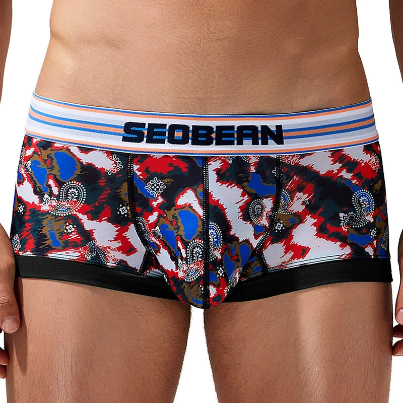 Front view of a person wearing colorful paisley camouflage mesh briefs with a SEOBEAN waistband