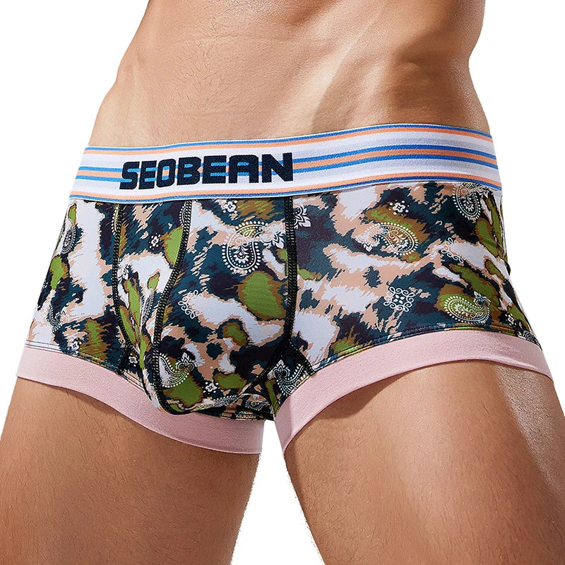 Front view of a model wearing camouflage-print mesh briefs with a striped SEOBEAN waistband