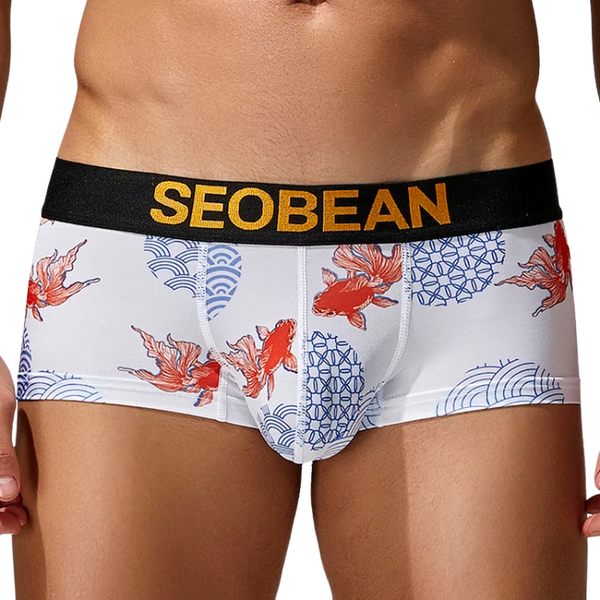 Front view of a model wearing white briefs with red fish and blue wave patterns