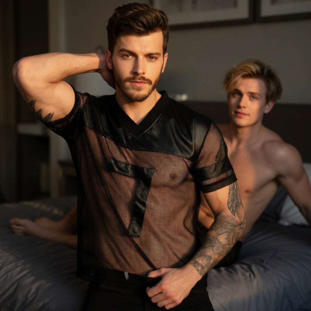Front-facing person modeling a black mesh football-style T-shirt with faux-leather trim
