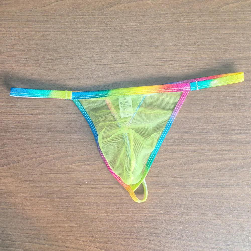 Front view of a neon rainbow sheer mesh thong laid flat on a wood surface