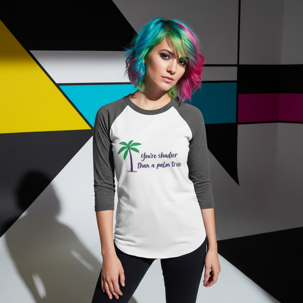Model wearing a white and charcoal raglan shirt with a palm tree and “You're shadier than a palm tree”