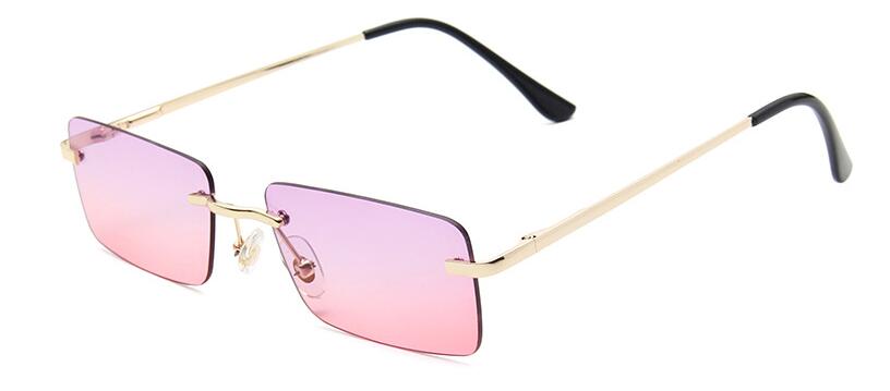 Angled view of rimless rectangular sunglasses with pink gradient lenses and gold arms