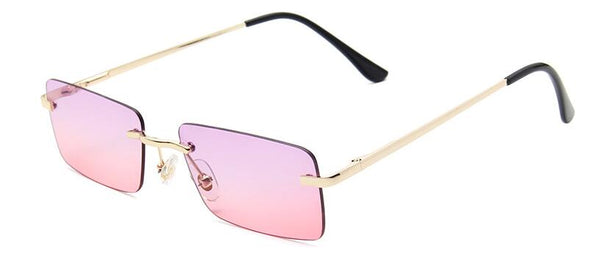 Angled view of rimless rectangular sunglasses with pink gradient lenses and gold arms