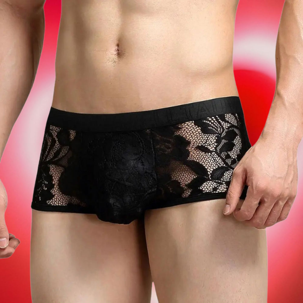 Front view of a model wearing black sheer floral lace boxer briefs