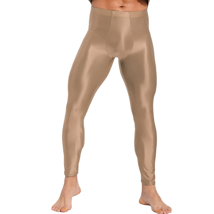 Front view of a model wearing shiny tan men's compression leggings, cropped above the waist