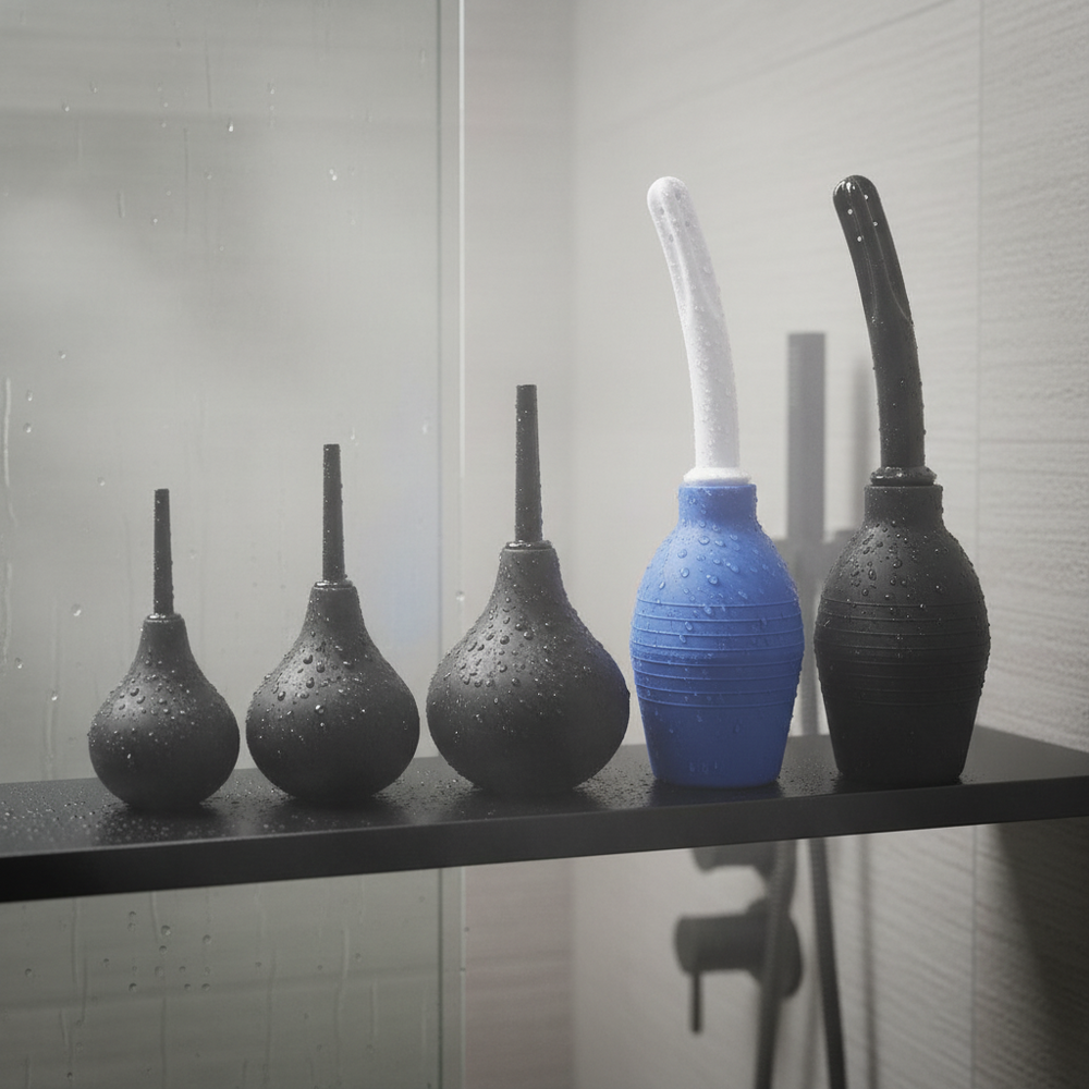 Five water-dropped silicone shower douches lined up on a shower shelf, in black and blue