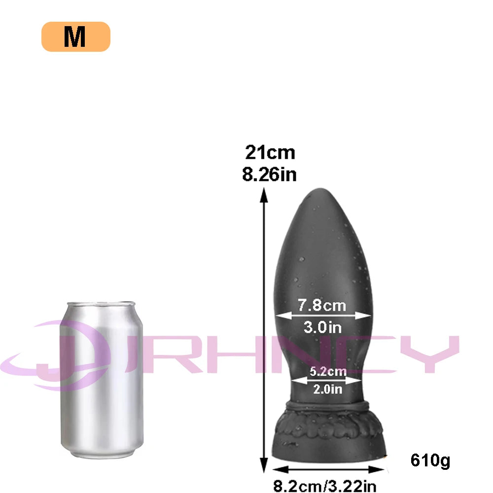 Black silicone XXL butt plug beside a can, with measurements and weight shown