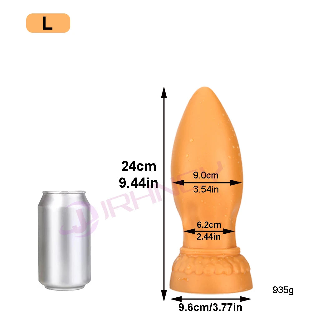 Orange silicone XXL butt plug beside a can for scale, with 24 cm size markings