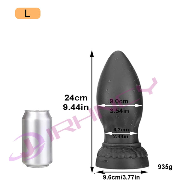 XXL black silicone butt plug shown beside a can with 24 cm dimensions and a wide flared base