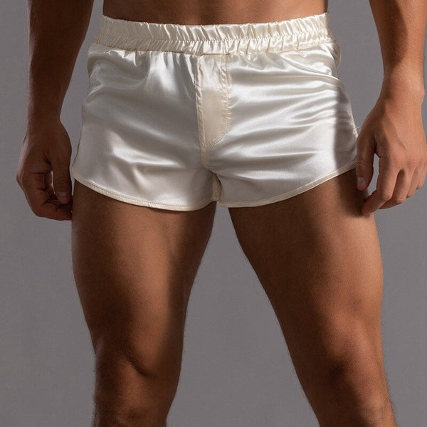 Front view of a model wearing glossy ivory satin short shorts