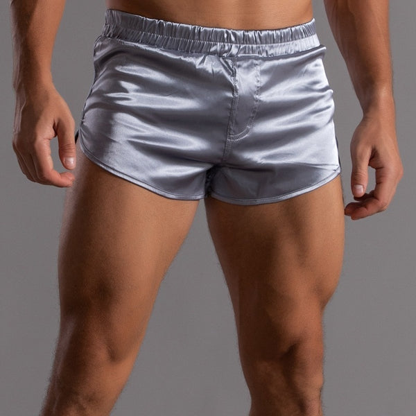 Front-view close-up of a model wearing shiny silver short shorts
