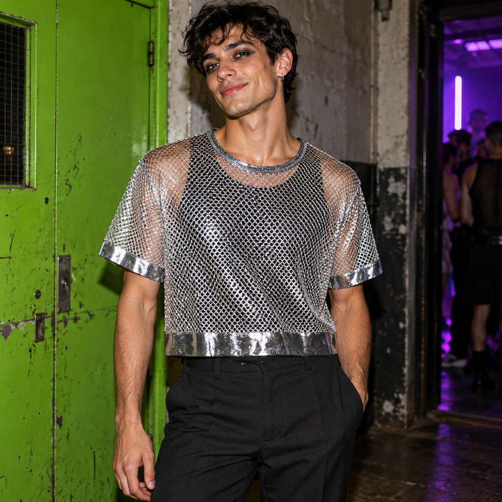 Model wearing the silver mesh short-sleeve crop top over a black tank outside a club with a lime-green door.