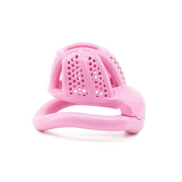 Pink plastic chastity cage with a perforated dome, shown from the front on white