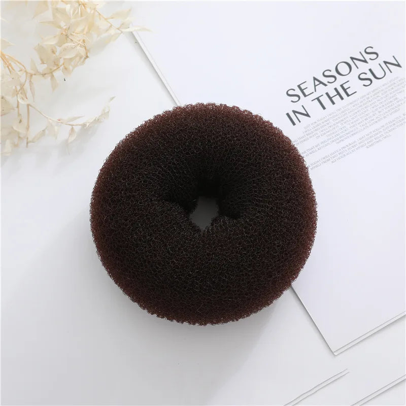Brown doughnut-shaped foam bun maker on a white magazine page