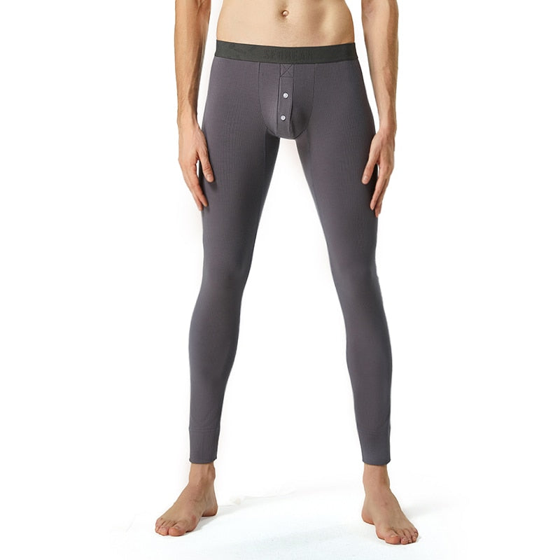 Front-view model wearing slim-fitting charcoal-gray thermal underwear bottoms