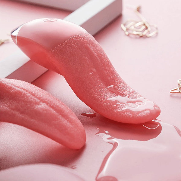 Close-up of a pink tongue-shaped vibrator with textured surface and glossy liquid