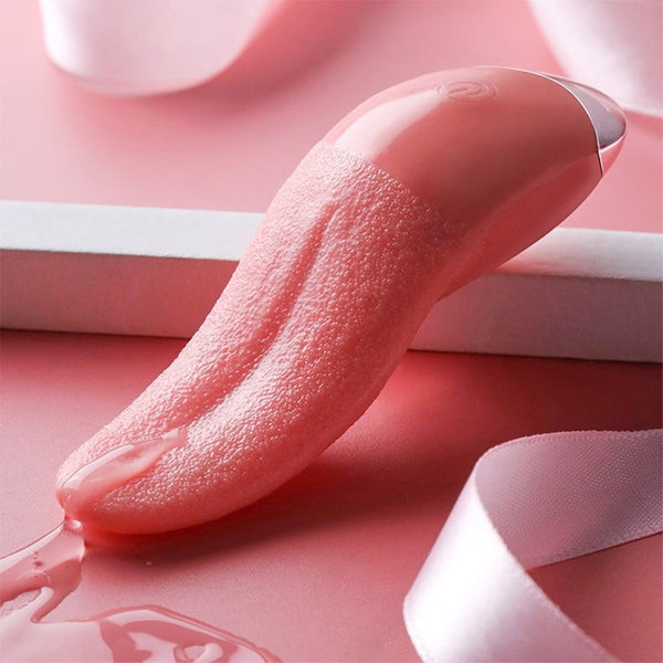 Pink tongue-shaped vibrator with textured surface, resting on a pink-and-white set