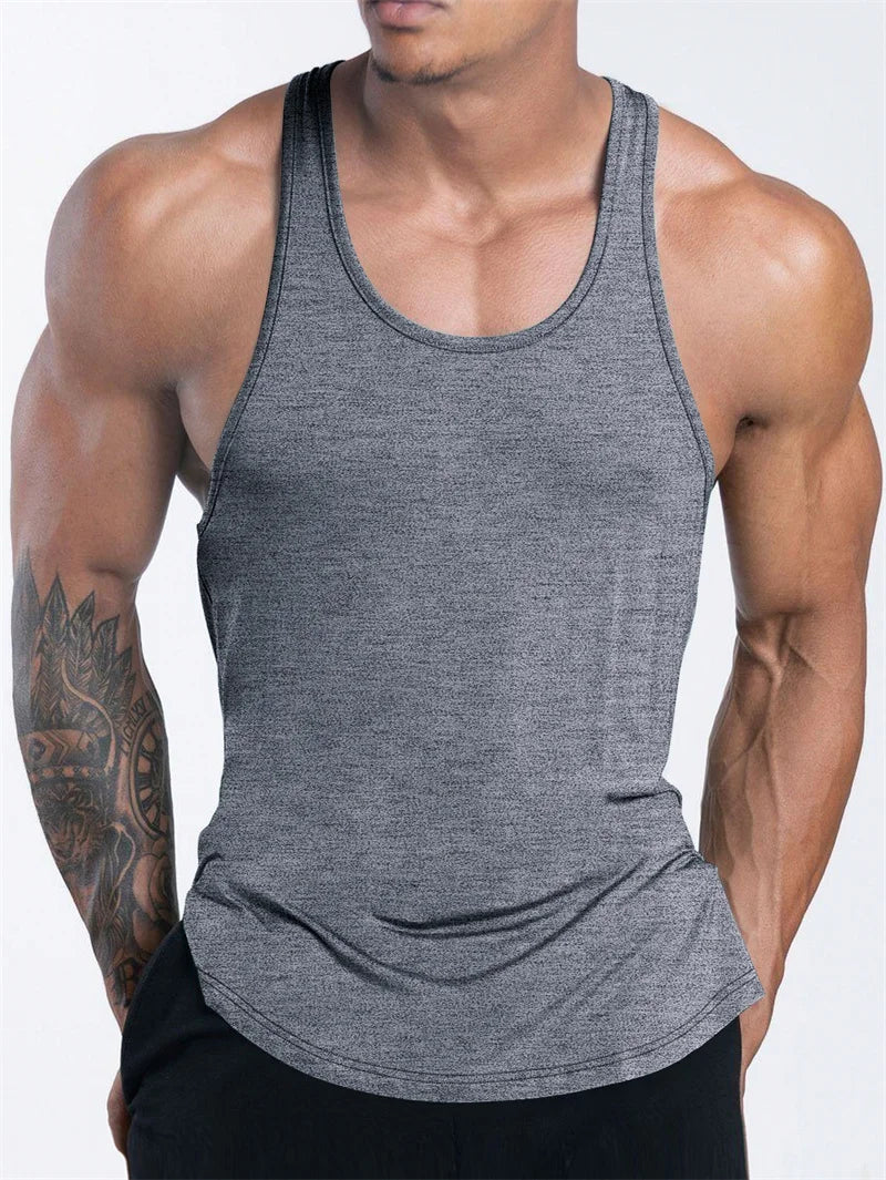 Front view of a muscular model wearing a heather-gray sleeveless tank top