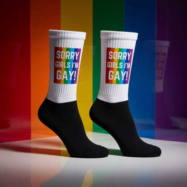 Crew-length socks in white and black, rocking a rainbow-striped patch with bold “Sorry Girls Im Gay!” text
