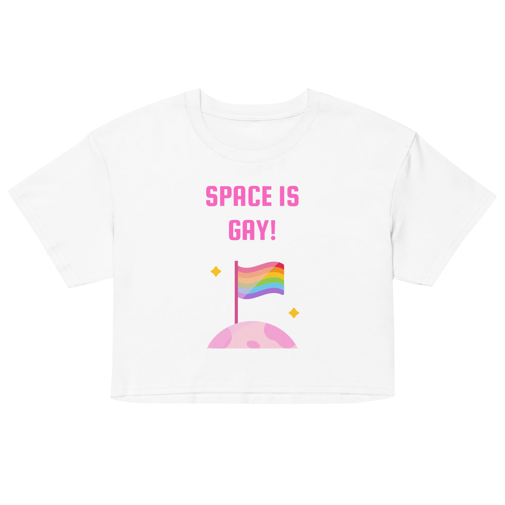 Front view of a white crop top reading “SPACE IS GAY!” above a rainbow flag on a pink planet