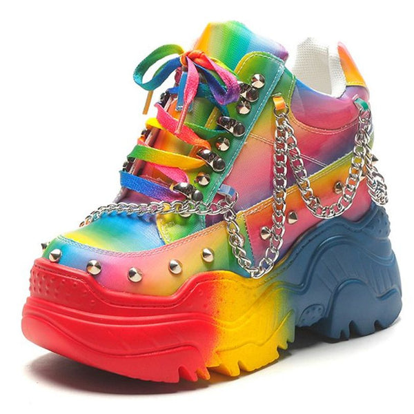 Pair of rainbow platform sneakers with studs, chains, and multicolored laces