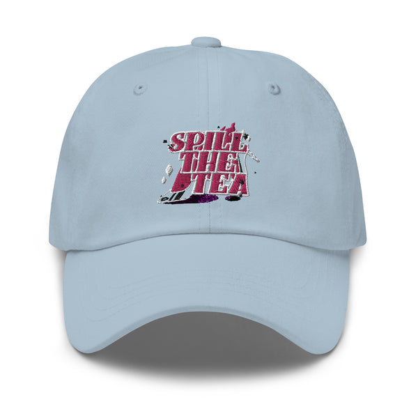 A light-blue, six-panel Spill The Tea Cap with pink and white embroidered text and a tea puddle detail